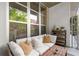 This charming balcony offers outdoor lounging with comfortable seating and tree views, extending the living space at 245 N N Highland Ne Ave # 220, Atlanta, GA 30307