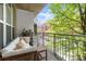 Inviting balcony featuring cozy seating, small table, and neighborhood views, perfect for relaxing outdoors at 245 N N Highland Ne Ave # 220, Atlanta, GA 30307