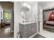 Bathroom with a large vanity, circular mirror, and views into both the bedroom and the shower area at 245 N N Highland Ne Ave # 220, Atlanta, GA 30307