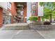 The building's exterior has a brick facade, large windows, and a manicured entrance area with greenery at 245 N N Highland Ne Ave # 220, Atlanta, GA 30307