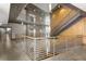 An open hallway featuring concrete accents, metal railings, stairs, and an elevator shaft at 245 N N Highland Ne Ave # 220, Atlanta, GA 30307