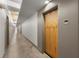 Long hallway with neutral walls and lighting, leading to various rooms at 245 N N Highland Ne Ave # 220, Atlanta, GA 30307