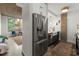 Bright kitchen showcasing stainless steel appliances and an adjacent living area with a large window at 245 N N Highland Ne Ave # 220, Atlanta, GA 30307