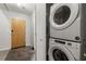 Hallway features stackable washer and dryer units, maximizing space and functionality at 245 N N Highland Ne Ave # 220, Atlanta, GA 30307