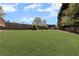 A lush green backyard featuring a play area and a well-maintained lawn at 2625 Cross Springs Dr, Cumming, GA 30041
