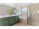 Bathroom featuring a soaking tub, walk-in shower, and double sink vanity for a spa-like experience at 2625 Cross Springs Dr, Cumming, GA 30041