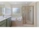 Bathroom featuring a soaking tub, walk-in shower, and double sink vanity for a spa-like experience at 2625 Cross Springs Dr, Cumming, GA 30041