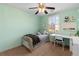 Cheerful bedroom with a ceiling fan, bed, and dedicated workspace for studying at 2625 Cross Springs Dr, Cumming, GA 30041