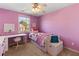 Cozy bedroom with pink walls, a ceiling fan, a window with natural light and a white desk at 2625 Cross Springs Dr, Cumming, GA 30041