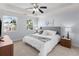 Bright bedroom with a ceiling fan, two windows, a comfortable bed, and neutral walls at 2625 Cross Springs Dr, Cumming, GA 30041