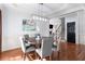 Bright dining area featuring a modern light fixture and a view of the staircase and living area at 2625 Cross Springs Dr, Cumming, GA 30041