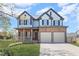 Beautiful two-story home featuring a classic design, stone accents, and an attached two-car garage at 2625 Cross Springs Dr, Cumming, GA 30041