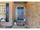 Inviting front entrance with a stylish blue door, stone accents, and a 'Welcome' mat at 2625 Cross Springs Dr, Cumming, GA 30041