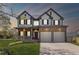 Charming two-story home showcasing a two-car garage, inviting porch, and manicured lawn at 2625 Cross Springs Dr, Cumming, GA 30041