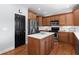 Well-lit kitchen featuring a center island, stainless steel appliances, and hardwood floors at 2625 Cross Springs Dr, Cumming, GA 30041