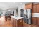 Open-concept kitchen features stainless steel appliances, an island, and views into the living room at 2625 Cross Springs Dr, Cumming, GA 30041