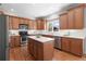 Modern kitchen with stainless steel appliances, a center island, and wooden cabinetry at 2625 Cross Springs Dr, Cumming, GA 30041