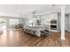 Open concept kitchen with white cabinetry, stainless steel appliances, and large center island with seating at 2625 Cross Springs Dr, Cumming, GA 30041