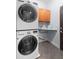 Compact laundry room with stacked washer and dryer maximizing space efficiency at 2625 Cross Springs Dr, Cumming, GA 30041