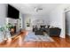Cozy living room featuring a fireplace, hardwood floors, and a comfortable sectional sofa at 2625 Cross Springs Dr, Cumming, GA 30041