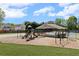 Community playground with multiple slides, swings, and a covered picnic area for Gathering enjoyment at 2625 Cross Springs Dr, Cumming, GA 30041