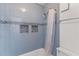 Bathroom with a tiled shower with blue accent tiles, providing a refreshing and stylish space at 305 Summit North Ne Dr # 305, Atlanta, GA 30324