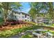 Exterior view of a two-story condo with a gazebo, bench seating, and lush landscaping at 305 Summit North Ne Dr # 305, Atlanta, GA 30324