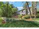 Exterior view of a two-story condo with lush landscaping and a gazebo at 305 Summit North Ne Dr # 305, Atlanta, GA 30324