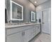 Bright bathroom featuring double vanity with white countertops, sleek hardware, and illuminated mirrors at 6380 Cortland Walk, Alpharetta, GA 30005