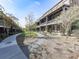 Beautifully landscaped courtyard featuring walkways, green space, and charming townhome exteriors at 6380 Cortland Walk, Alpharetta, GA 30005