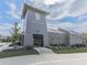 Attractive exterior Halcyon building with metal roof, grey siding, brick accents, and manicured landscaping at 6380 Cortland Walk, Alpharetta, GA 30005