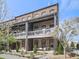 Inviting brick townhouse with covered balconies and well-manicured landscaping, perfect for relaxed outdoor living at 6380 Cortland Walk, Alpharetta, GA 30005