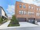 Brick townhomes with attached garages and contemporary design on a sunny day at 6380 Cortland Walk, Alpharetta, GA 30005