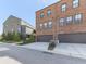 Brick townhomes showcasing attached garages and contemporary design elements at 6380 Cortland Walk, Alpharetta, GA 30005