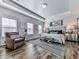 Serene bedroom features hardwood floors, tray ceiling, neutral walls, and plenty of natural light at 6380 Cortland Walk, Alpharetta, GA 30005