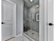 Modern glass shower featuring gray subway tile and mosaic tile floor in a newly constructed home at 6380 Cortland Walk, Alpharetta, GA 30005
