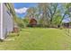 Spacious backyard with lush green grass, mature trees, and a shed at 3326 Chappel Lane, Peachtree Corners, GA 30360