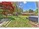 Spacious backyard with a lush lawn, mature trees, and a detached shed, offering a serene outdoor space at 3326 Chappel Lane, Peachtree Corners, GA 30360