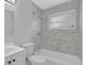 Modern bathroom with elegant white vanity and luxurious marble-style tiled shower and tub at 3326 Chappel Lane, Peachtree Corners, GA 30360