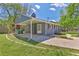 Charming one-story home with blue painted brick, a covered carport, and a well-manicured front lawn at 3326 Chappel Lane, Peachtree Corners, GA 30360