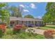Landscaped front yard showcasing vibrant red flowers enhancing the curb appeal of this cozy home at 3326 Chappel Lane, Peachtree Corners, GA 30360