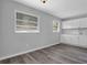 Open kitchen area with gray vinyl floors, white cabinets, a white countertop and natural light streaming through the windows at 3326 Chappel Lane, Peachtree Corners, GA 30360