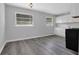 Open kitchen area with gray vinyl floors, white cabinets, and a black gas stove, blending style and function at 3326 Chappel Lane, Peachtree Corners, GA 30360