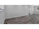 Spacious living room features gray vinyl floors and neutral walls, creating a cozy, modern living space at 3326 Chappel Lane, Peachtree Corners, GA 30360
