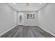 Bright living room featuring sleek gray vinyl floors, a decorative front door, and modern recessed lighting at 3326 Chappel Lane, Peachtree Corners, GA 30360