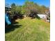 Fenced backyard with mature trees, playset, and lush lawn provide ample space for outdoor activities at 5485 Mountain Top Pl, Cumming, GA 30041