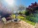 Outdoor living with brick patio, grill, fire pit and colorful landscaping at 5485 Mountain Top Pl, Cumming, GA 30041