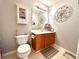 Well-lit bathroom with a vanity, toilet, and decorative mirror, creating a clean and functional space at 5485 Mountain Top Pl, Cumming, GA 30041