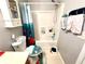 Cozy bathroom with a sink, toilet, and a shower with a bright, patterned curtain at 5485 Mountain Top Pl, Cumming, GA 30041