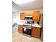 Functional kitchen with ample wood cabinets, stainless steel appliances, and tiled flooring at 5485 Mountain Top Pl, Cumming, GA 30041
